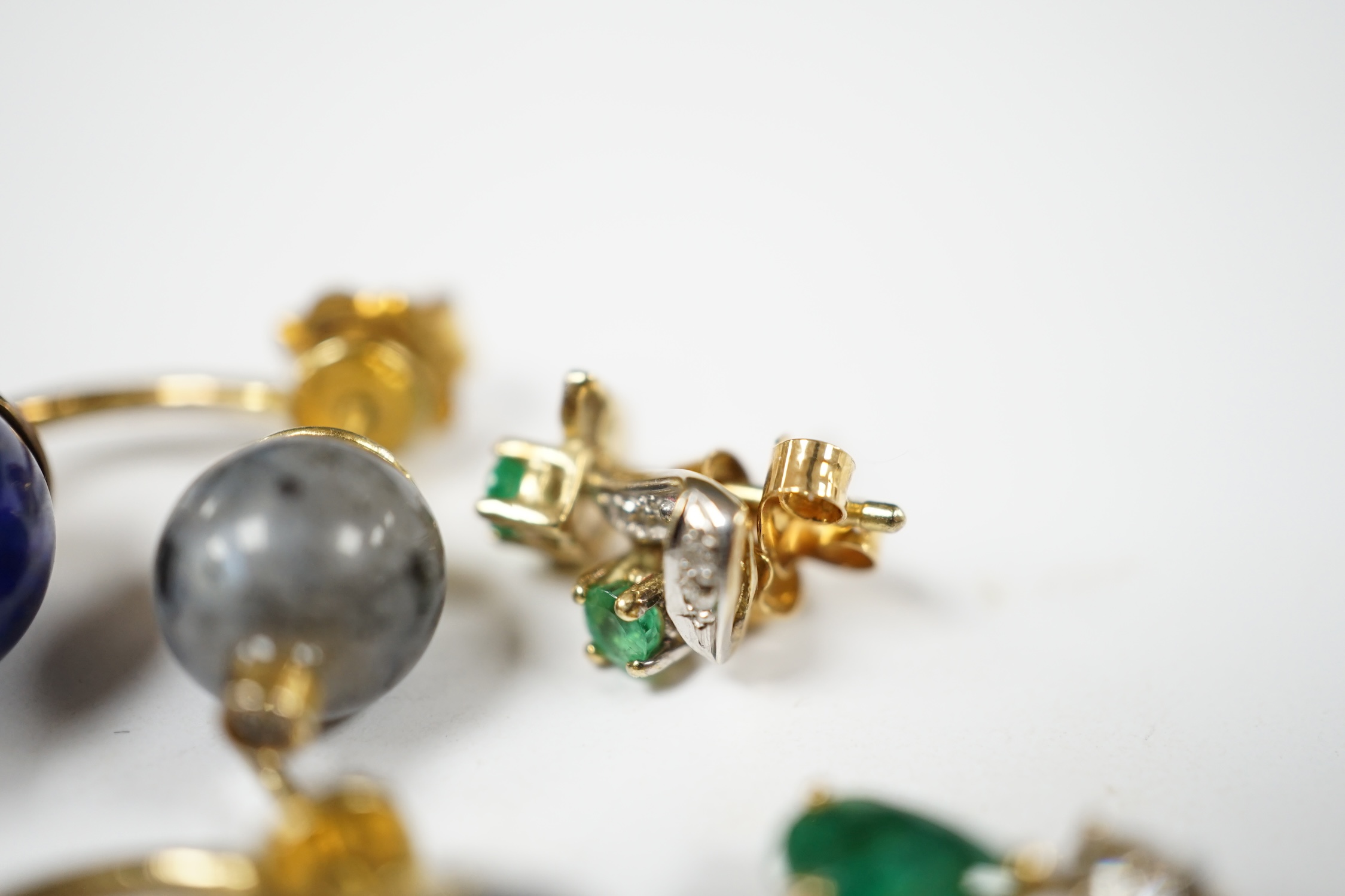 A modern small pair of yellow metal, emerald and diamond set ear studs, a similar pendant and a pair of lapis lazuli, hardstone and diamond chip set ear studs. Condition - fair